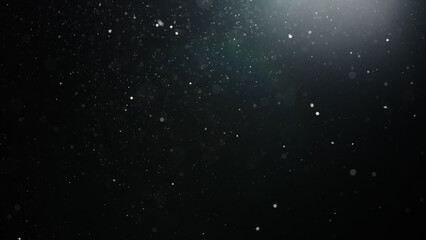 Fototapeta premium Slow motion real dust particles floating mid air over dark background