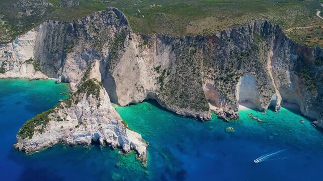 Spectacular drone view of Plakaki rocky coastline in Zakynthos. Dramatic white limestone cliffs and deep turquoise Ionian Sea water in a rugged and scenic Greek island landscape.