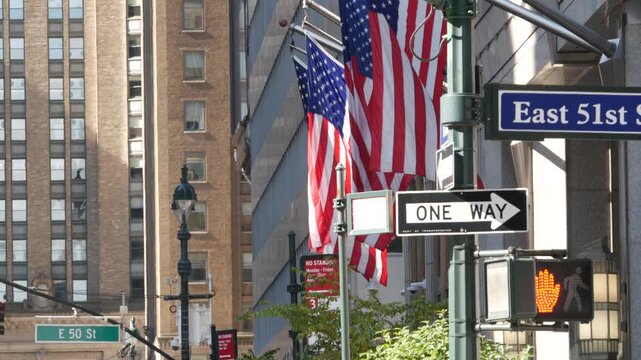 New York City Park Avenue, street sign in Manhattan Midtown, United States. Urban road sign, traffic sign in NYC, USA. Building architecture near Grand Central. One way arrow and American flag.