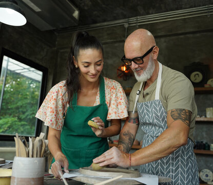 A happy couple makes ceramic plates in a workshop