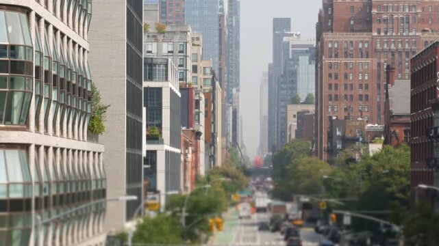 Manhattan Midtown straight street, 10 tenth avenue New York City, United States of America. Hells Kitchen district from Chelsea. Urban architecture symmetry, cars on road from above. High Line park.