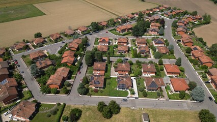 A captivating bird's-eye perspective showcases a meticulously planned residential district. Each house stands as a symbol of domestic tranquility and modern living. Caleppio, Lombardy, Italy © Andrew