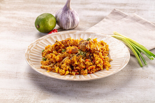 Savory fried rice with meat and vegetables served on a plate with fresh ingredients