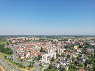 Fototapeta premium Urban Panorama: Aerial view of a charming town, captured on a sunny day. The scene showcases a tapestry of architecture and infrastructure, inviting exploration.