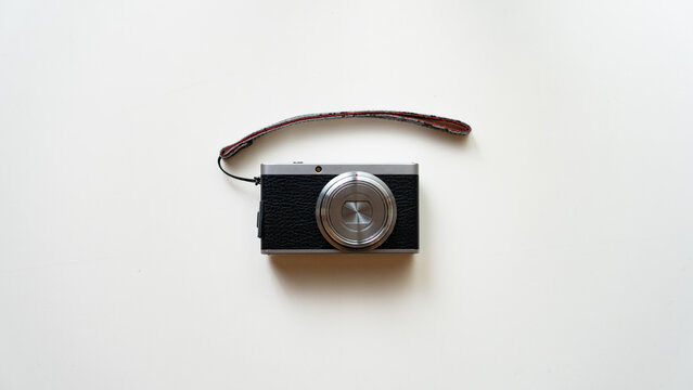 Compact Vintage Style Camera on White Background Flat Lay