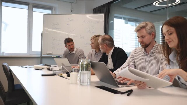 Group of happy progressive business people working on startup together at creative office