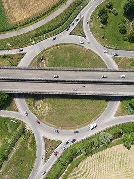 Aerial View of a Busy Highway Interchange: An overhead perspective captures the intricate network of roads and traffic flow at a major highway interchange.