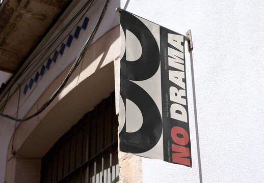 Mockup of a Storefront Sign Hanging on a Wall