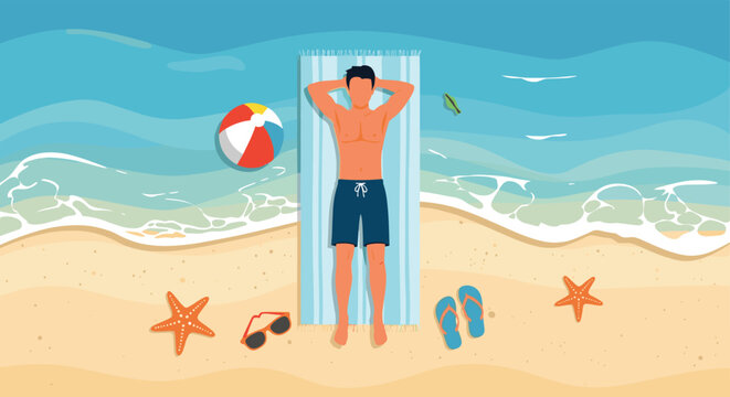 Top view of a man sunbathing on a blue striped towel at a sandy beach with a beach ball and sea stars near the waves.