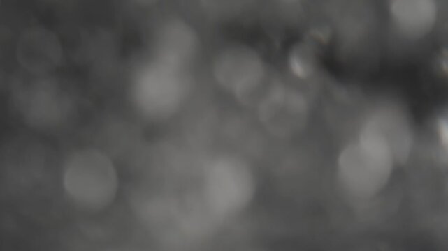 Macro view of bubbles in a glass of clear water, blurred background