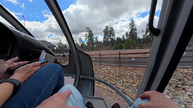 First person view from inside a helicopter cockpit as it takes off from a heliport in arizona for a scenic flight over the stunning landscape of the grand canyon national park