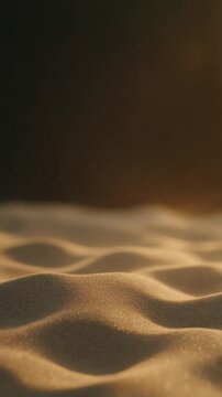 Sand particles blow across rippled desert dunes in golden light