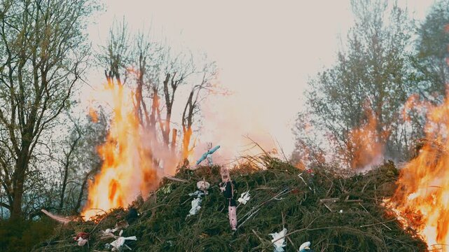 Ignition of large bonfire with flames rising during spring festival near Liberec Czech Republic Europe