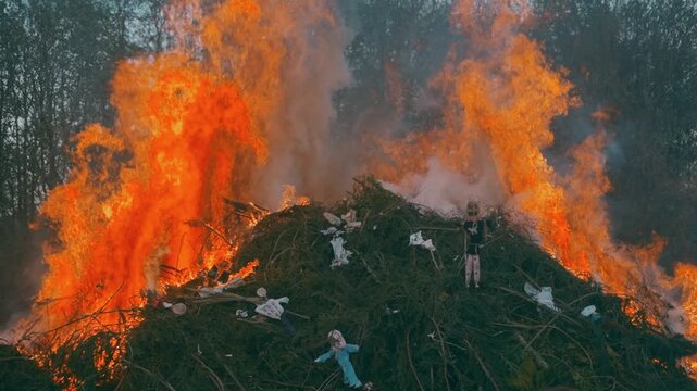 Man standing with burning bonfire in background during spring festival near Liberec Czech Republic Europe