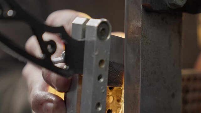 Knife is sharpened by blacksmith in workshop during making