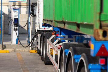 Naklejka premium EV semi-truck refueling at an industrial power hub.