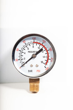 Analog pressure gauge mounted on industrial machine panel for compressed air monitoring, mechanical dial instrument showing MPa scale for pneumatic system control and technical maintenance