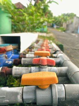 Close-up of industrial grade U-PVC water control valv for domestic water supply system.