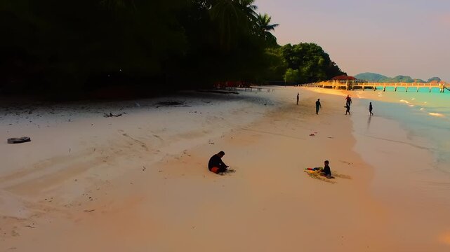 Malaysia, Terengganu - August 27, 2018 Aerial forward view of people at Redang Island beach.
