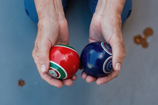 Senior woman hands hold two decorative chinese baoding balls. Exercise improves dexterity, strength, and promotes relaxation. Traditional health aid.