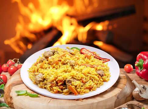 Traditional uzbek lamb pilaf with rice, garlic and spices cooked over an open fire.
