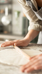 Obraz premium Kneading dough at the kitchen table
