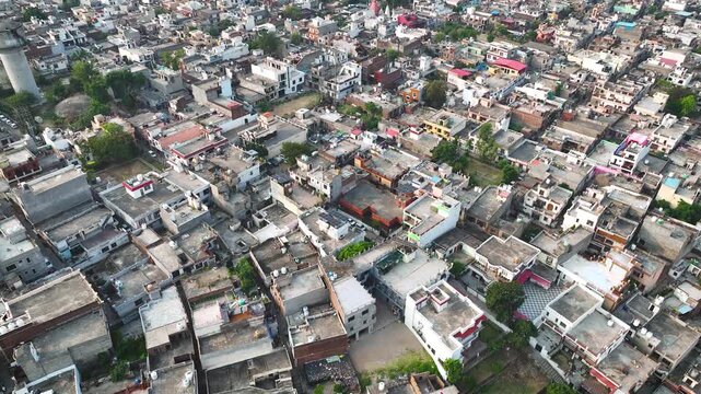 Aerial view of dense domestic housing and green trees in Jammu suburb