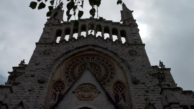 Mallorca, Spain. 07-28-2026. Church of Sant Bartomeu S&oacute;ller facade with leaves frame. Slow motion 4K