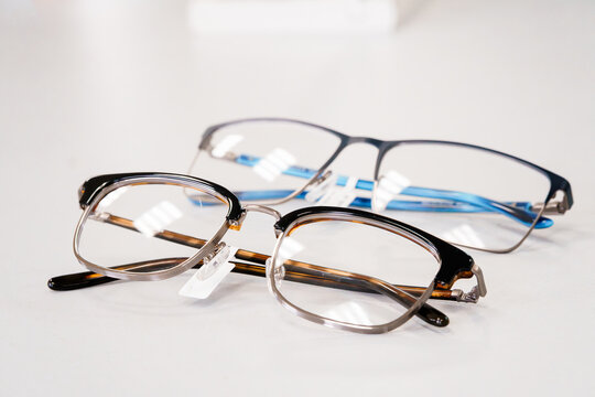 Two pairs of prescription eyeglasses with tortoise shell and blue frames isolated on white background