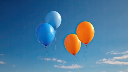 Obraz premium Four brightly colored balloons float against a clear blue sky with scattered white clouds