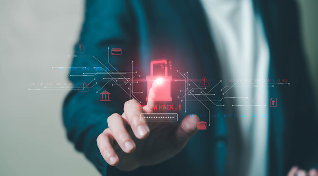 Business professional using laptop with holographic cyberattack warning and system hack alert interface. Concept of cybersecurity threat, data breach, ransomware attack, online fraud.
