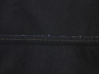 Black Fleece Fabric Texture Background with Internal Seam Detail © sunkit