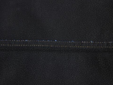 Black Fleece Fabric Texture Background with Internal Seam Detail