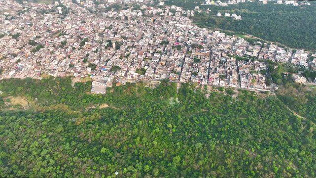 Drone Tilt up reveal shot highlighting severe habitat loss and Deforestration leading to regional expansion.