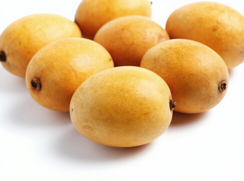 Group of ripe marula fruits with golden skin shown on clean white background. Tropical produce is fresh and ready for consumption or juice. These fruits have a distinct appearance and subtle texture.
