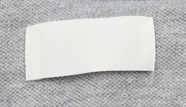 White blank label tag on clothes close-up 