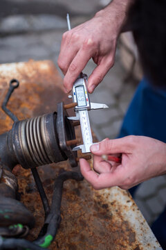 caliper in the hands of the master, measuring the dimensions of the part