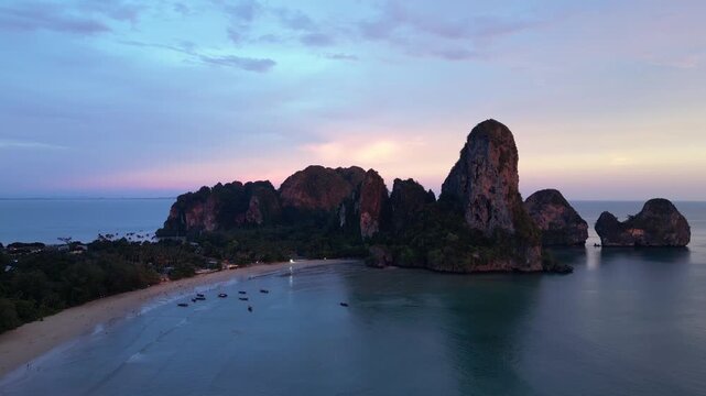 Railay beach, Thailand: Aerial orbit drone footage of the dramatic Railay, or Raliey beach in Krabi in Thailand by the Andaman sea at sunset famous for its karst landscape