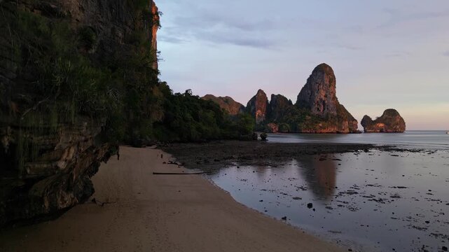 Krabi, Thailand: Aerial drone footage of the dramatic Karst landscape of Railay, or Raliey beach in Krabi in Thailand by the Andaman sea. Shot with an upward motion from Tonsai beach