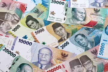 Indonesian rupiah money banknotes pile on table. Indonesia bills of IDR currency close up © Larysa