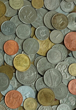 Heap of colorful coins from different countries, macro photography. International currency