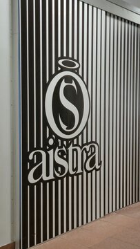 Vilnius Lithuania 02.04.2026 Aistra intimate boutique logo on striped monochrome wall inside shopping mall with modern branding and minimalist retail design concept