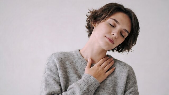 Woman with eyes closed hand on chest