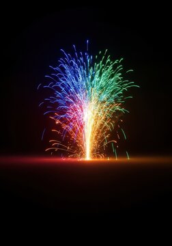 Dynamic, instantaneous eruption of colorful sparks and bright light captured against a dark, nocturnal background. Intense pyrotechnic burst, gunpowder, energy, flame