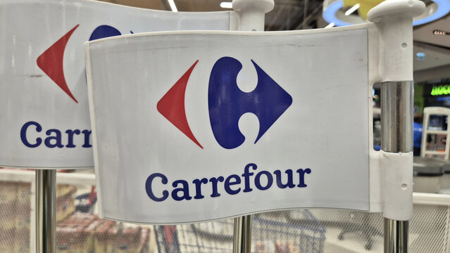A close-up of a white plastic safety flag from a child's shopping cart featuring the Carrefour logo and brand name. Picture taken on May 8, 2026 in Bucharest, Romania.