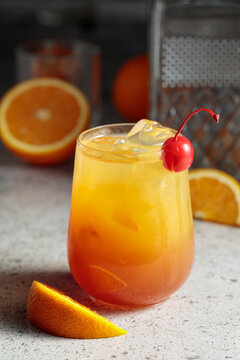 Cocktail Tequila sunrise with ice, orange juice, grenadine, and silver tequila.