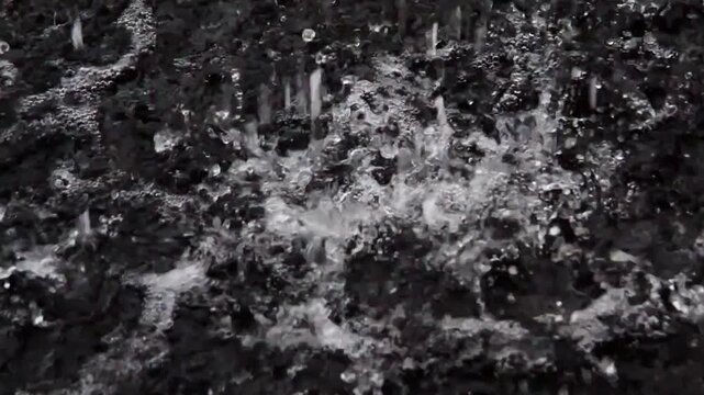The captivating splash of water, a symphony of motion and form, creating a mesmerizing pattern in monochrome