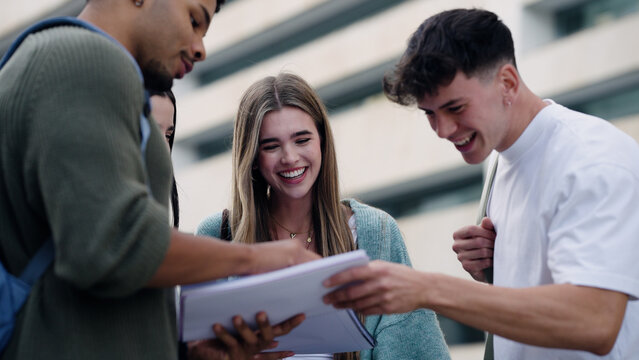 Group of young students interacting and discussing academic material outdoors. Sharing joy and connection during their education