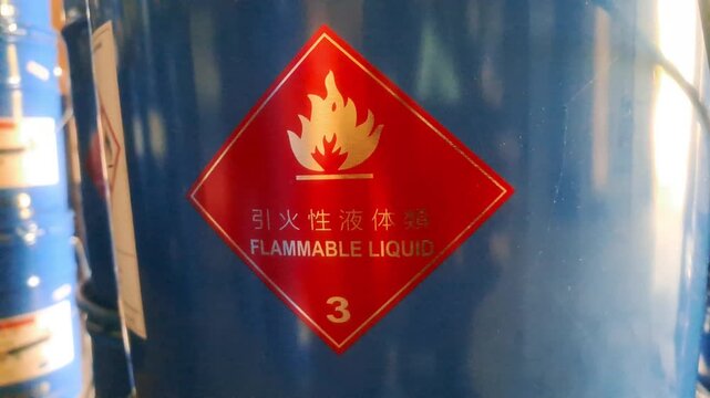 a blue barrel with a red sticker on it