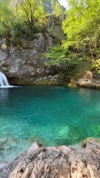 Beautiful landscape of the Blue Eye (Syri i Kalt&euml;r) natural spring in Theth, Albania. A deep turquoise mountain pool fed by a small waterfall, surrounded by the wild nature of the Albanian Alps 